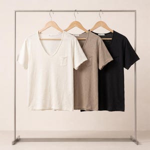 May include: A set of three ceramic mugs with a speckled, matte finish. The mugs are in shades of cream, light gray, and dark gray. Each mug has a simple, minimalist design, perfect for coffee or tea.