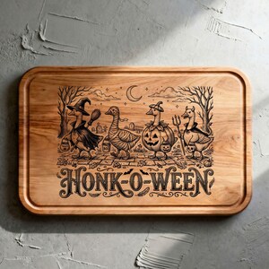 May include: A rectangular wooden cutting board featuring a black laser-engraved illustration of four geese in Halloween costumes, including a witch, a mummy, a pumpkin, and a devil, with the text HONK-O-WEEN printed in a decorative font below.