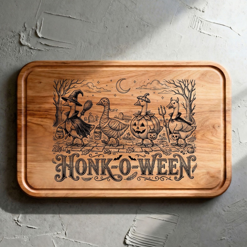 May include: A rectangular wooden cutting board featuring a black laser-engraved illustration of four geese in Halloween costumes, including a witch, a mummy, a pumpkin, and a devil, with the text HONK-O-WEEN printed in a decorative font below.