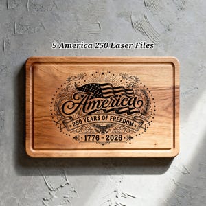 May include: A rectangular wooden cutting board featuring a laser-engraved design with an American flag, the word America, and the text 250 YEARS OF FREEDOM 1776 - 2026. The board has a smooth, light brown wood grain finish and rounded edges.