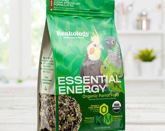 May include: A green bag of Beakology Essential Energy organic parrot food. The bag features images of parrots and text including "Certified Avian Specialist Formulated" and "USDA Organic". The bag contains 2 lbs (907 g) of food.