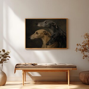 May include: A framed artwork featuring a portrait of three greyhounds. The dogs are depicted in profile, with varying shades of grey, tan, and black. The artwork is displayed above a wooden bench with a cushion.