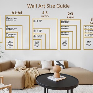 May include: Wall art size guide with various frame sizes and ratios, including A1-A4, 4:5, 2:3, and 3:4. Sizes are listed in inches and centimeters. The guide is displayed on a white wall above a beige sofa and black coffee table.