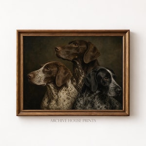 May include: A framed print featuring three German Shorthaired Pointers. The dogs are depicted in a classic portrait style, with varying shades of brown and black. The print is in a wooden frame, with the text "ARCHIVE HOUSE PRINTS" at the bottom.