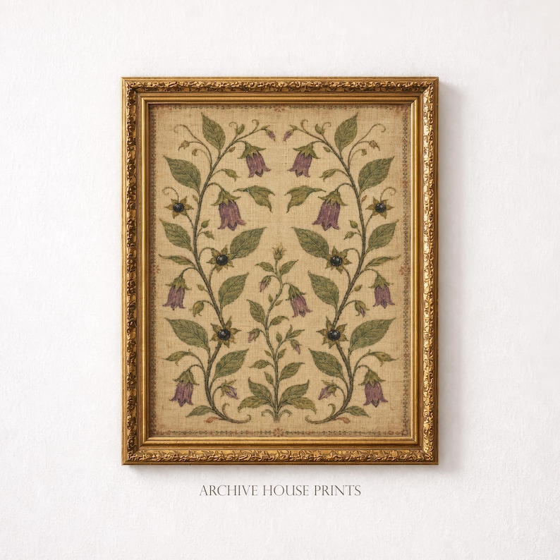 May include: A framed wall art print featuring a symmetrical botanical illustration of purple bell-shaped flowers and green leaves on a textured beige background. The artwork is enclosed in an ornate, metallic gold-toned rectangular frame.