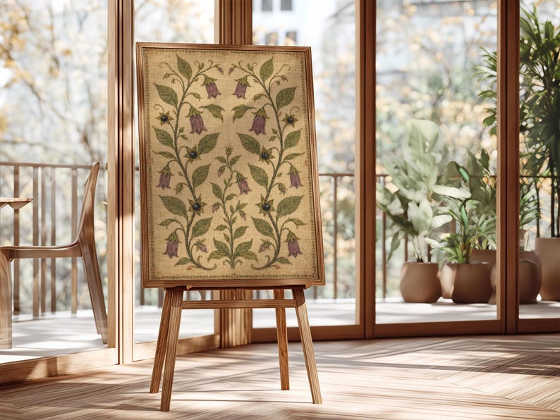 May include: A rectangular framed artwork featuring a symmetrical botanical illustration on a textured beige background. The design displays green leafy vines with purple bell-shaped flowers and small dark berries, all enclosed in a wooden frame.
