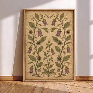 May include: A rectangular framed wall art print featuring a symmetrical botanical illustration on a textured beige background. The design displays green vines with purple bell-shaped flowers and small dark berries, enclosed by a thin decorative border.