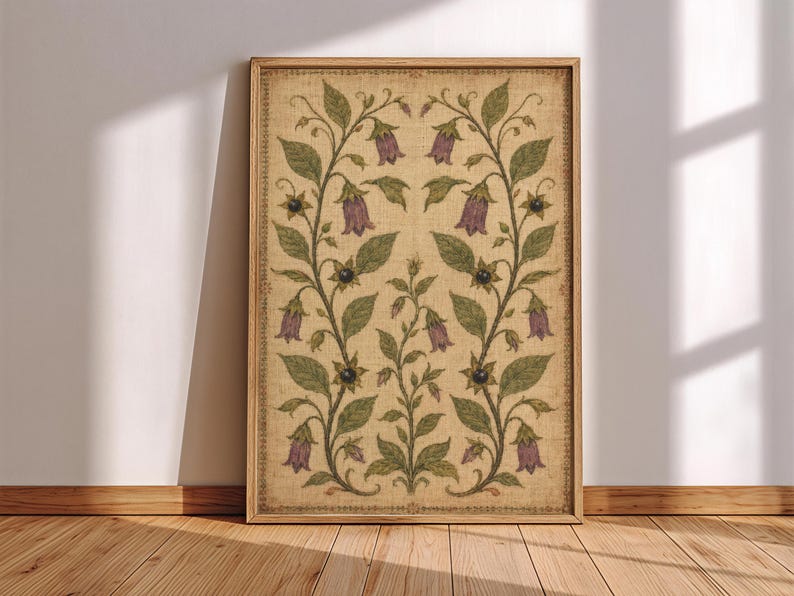 May include: A rectangular framed wall art print featuring a symmetrical botanical illustration on a textured beige background. The design displays green vines with purple bell-shaped flowers and small dark berries, enclosed by a thin decorative border.
