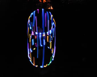 May include: A colorful light show with blue, purple, yellow, and green lights creating a swirling pattern.