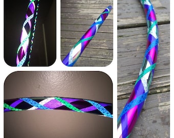 May include: A colorful hoop with a purple, green, blue, white, and silver reflective tape design. The hoop is made of plastic and is approximately 40 inches in diameter.
