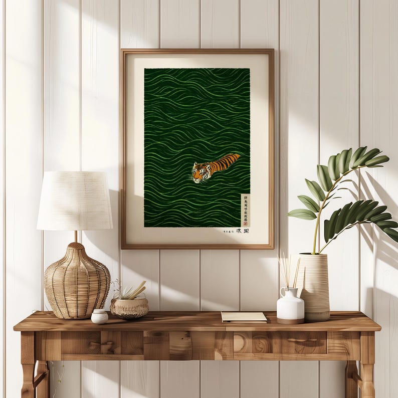 May include: Framed art print featuring a tiger swimming in green water with wave patterns. The tiger has orange and black stripes. The artwork is in a wooden frame and includes Japanese text.