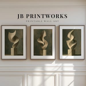 May include: Three framed prints titled JB PRINTWORKS PRINTABLE WALL ART. Each print features a beige, abstract, swirling sculpture on a square base against a dark, muted green background. The frames are thin and dark, displayed in a horizontal row.