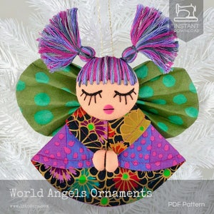 May include: A handmade felt angel ornament with a purple and pink dress, green wings with white polka dots, and a pink face with closed eyes. The ornament is hanging from a gold string. "World Angels Ornaments" and "PDF Pattern" are written at the bottom of the image.