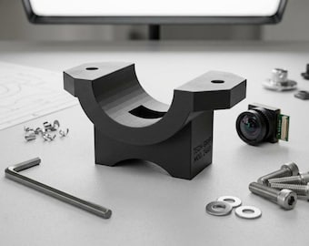 May include: A black, curved bracket with two holes, a small camera, screws, washers, and an Allen wrench are arranged on a light gray surface. A blueprint and metal shavings are also present. The bracket has the text "TECH-GRIP MOD 244".