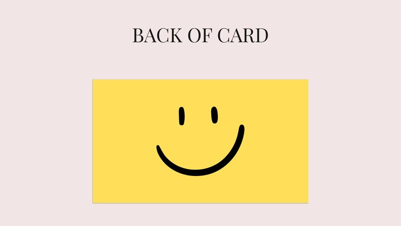 May include: A yellow card with a black smiley face and the text "BACK OF CARD" in black. The card has a light pink background.