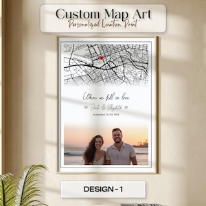 May include: A framed custom map art print with the text "Custom Map Art Personalized Location Print." The print features a black and white map with a red heart marker, the text "Where we fell in love," and a photo of a couple. The text "DESIGN-1" is at the bottom.