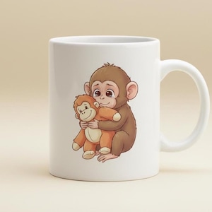 May include: White ceramic mug featuring a cartoon illustration of a brown monkey hugging a smaller orange monkey. The design is centered on the mug, with a white handle on the right side. The mug has a glossy finish and is suitable for hot or cold beverages.