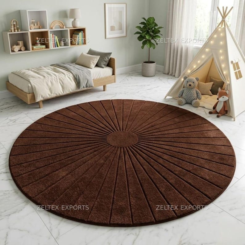 May include: A large, circular, dark brown area rug featuring a sunburst pattern with radiating lines extending from a solid center circle. The rug has a textured, plush surface and is positioned on a white marble-patterned floor.