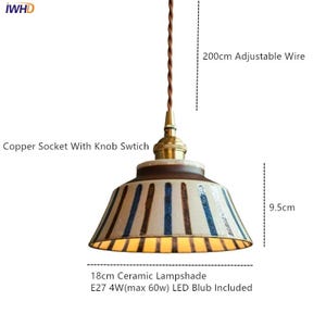 May include: Ceramic pendant light with a brown and cream lampshade, adorned with vertical blue stripes. Features a copper socket with a knob switch and a 200cm adjustable wire. The lampshade is 18cm wide and 9.5cm tall.