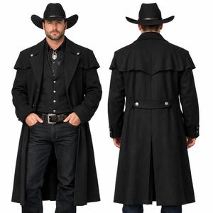 May include: A black cowboy duster coat with a matching cowboy hat. The coat features a long length, a button-up front, and a cape-like design over the shoulders. The model is wearing a black vest, shirt, and jeans.