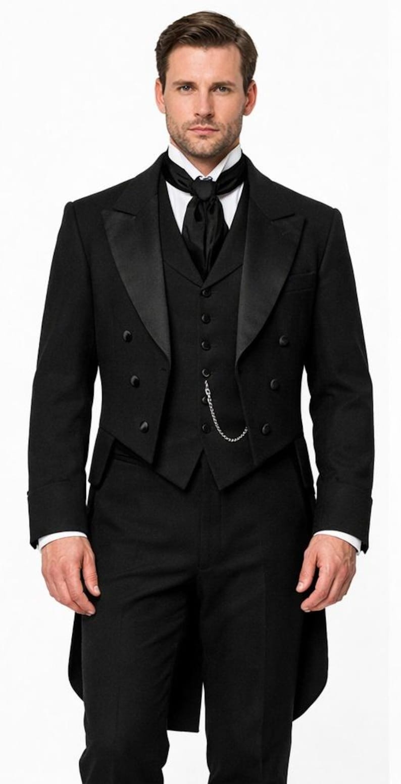 May include: A formal black tuxedo with a notched lapel, double-breasted jacket, and matching vest. The suit includes a white dress shirt, black tie, and a silver chain. The tailored suit is suitable for formal events and special occasions.