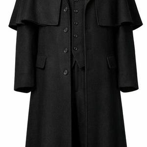 May include: A black wool coat with a cape-like shoulder design, a vest, and a tie. The coat has a long, tailored silhouette with a button-down front and pockets. The outfit is displayed on a mannequin.