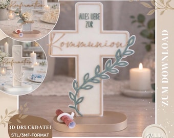 May include: A white cross-shaped Communion decoration with the words "Alles Liebe Zur Kommunion" and a green leaf design. The decoration is on a beige base, with a small scroll and candles in the background.