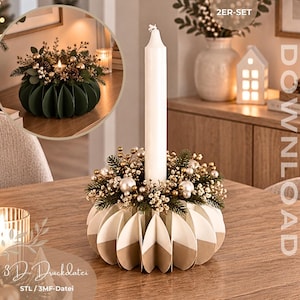 Op de afbeelding: Een witte taps toelopende kaars staat in een ronde, geplooide papieren kaarsenhouder in wit en beige. De basis is versierd met kunstmatige dennennaalden, kleine gouden bolletjes en witte bessen. Tekst: 2ER-SET en 3D-Druckdatei.