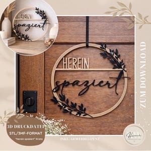 May include: A wooden circular sign with the words "HEREIN spaziert" in black script and block letters. The sign has a natural wood finish and is adorned with black leaf accents. It is hanging on a wooden door.