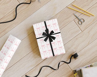 Rollo de papel para envolver regalos con estampado de lazo rosa, papel para envolver regalos con un toque tierno.