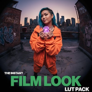 May include: A person with blue hair wearing an orange jacket and pants holds a glowing purple square. The text "THE INSTANT FILM LOOK LUT PACK" is displayed in green at the bottom of the image. The background features a city skyline.