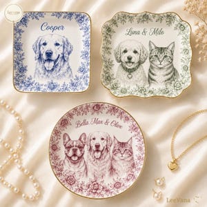 May include: Three ceramic trinket dishes with gold rims. One square blue dish features a golden retriever and the name Cooper. One square green dish features a dog and cat with the name Luna & Milo. One round burgundy dish features three pets and the name Bella, Max & Olive.