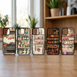 May include: Five phone cases with black borders, each featuring a different kitchen-themed illustration. Designs include a stove, shelves of jars, and a pantry scene. The cases are displayed on a wooden surface.