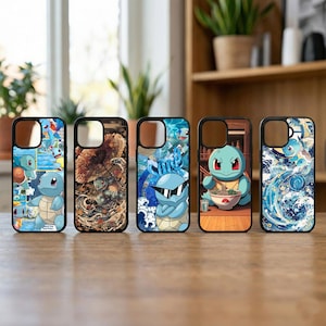 May include: Five phone cases with black borders and various designs featuring a blue turtle-like character. The designs include the character in different poses, with sunglasses, and in a ramen bowl. The cases are on a wooden surface.