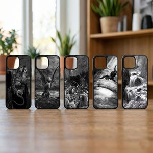 May include: A collection of five black and white phone cases with gothic illustrations. Each case features a different detailed artwork, including figures with wings, and scenes of figures in a dramatic setting. The cases are displayed on a wooden surface.