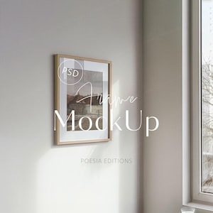 May include: A framed artwork mockup with a light wood frame, hanging on a neutral wall. The artwork features a landscape scene with a building. The text "Frame MockUp" is overlaid on the image, along with the text "POESIA EDITIONS".