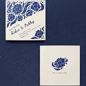 May include: A square save the date card featuring blue floral illustrations, with the text Robin & Oakley, Friday, July 31, 2026, Clover & Moss Farm 14 Wheedrawing Lane, Millbrook, NY. A second square card displays a single blue flower and the text Formal invitation to follow.