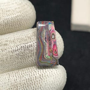 May include: A white ceramic mug with a black handle and the text "But First, Coffee" in a black, handwritten-style font. The mug is on a white surface.