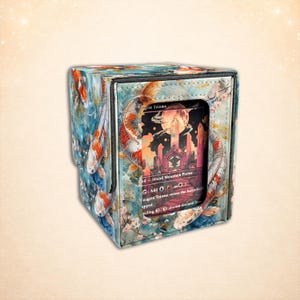 May include: A white ceramic mug with a black handle and the text "But First, Coffee" in a black, handwritten-style font. The mug is on a white surface.