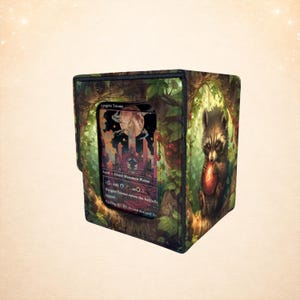 May include: A card storage box with a forest and raccoon design. The box features a card with text that reads "Augrin Triome". The box is green, brown, and black.