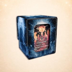 May include: A blue and black card storage box with a fantasy card. The box has a textured design with a wolf image on the side. The card shows a red moon and a city. The text on the card reads "Island Mountain Plains".