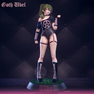 May include: A figurine of a female anime character with green hair and purple eyes, wearing a black outfit with a pentagram design. The figure is standing on a green base with the name "Abel" and the text "Goth Abel" at the top.
