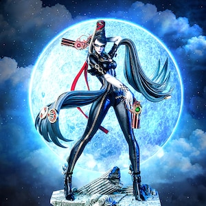 May include: A detailed figurine of a woman in a black bodysuit, holding two guns, with long black hair. The figure stands on a stone base with a sculpted face, set against a backdrop of a full moon and a cloudy night sky.