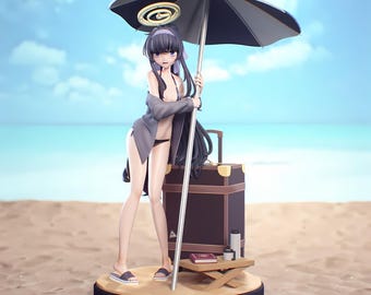 May include: A figurine of a woman in a swimsuit, holding a beach umbrella. She is standing on a sandy beach with a suitcase and small table. The umbrella is black and white, and the sky is blue.