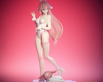 May include: A figurine of a woman in a white and pink bunny suit with long pink hair and bunny ears. A smaller bunny figurine is at her feet, resting on a flower-shaped base. The background is a solid pink.