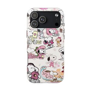 May include: White phone case featuring a repeating pattern of Snoopy characters in various poses, including Snoopy in a dinosaur costume and holding a heart. The case has a camera cutout for a triple-lens system.