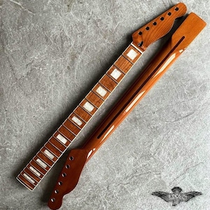 May include: Two unfinished guitar necks. One neck features a fretboard with white inlays and the other shows the back of the neck. Both are a warm brown color. The headstock has tuning peg holes.