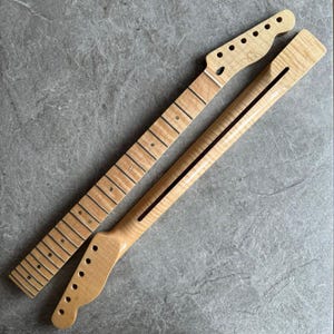 May include: Two unfinished maple guitar necks. One neck has frets and dot inlays, the other has a black stripe down the center. Both necks have a natural wood grain finish and are ready for assembly.