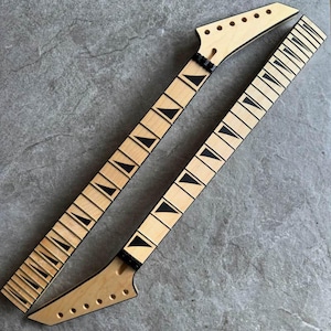 May include: Two unfinished guitar necks with light wood and black fret markers. The necks have a natural wood finish and are angled, with tuning peg holes at the headstock. The fretboards have black triangular inlays.