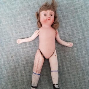 1900s nippon bisque mignonette jointed doll with wig and painted face and shoes
